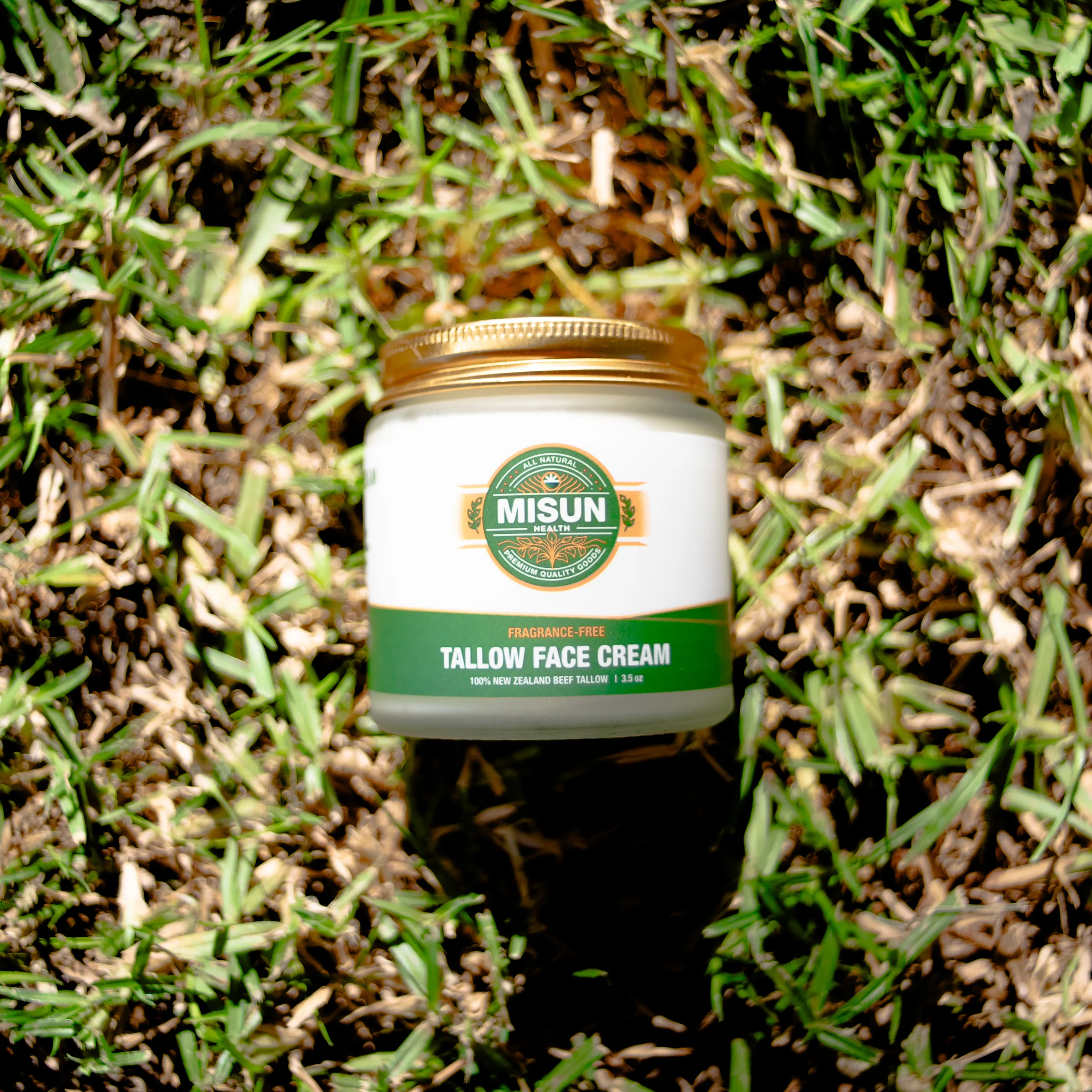 Misun Health tallow jar resting on sunlit grass